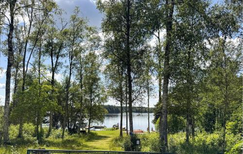 a park bench in front of a lake at 3 Bedroom Pet Friendly Home In Nässjö in Nässjö
