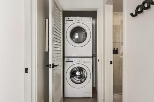a laundry room with two washing machines in it at Tide House - Unit C - Modern Seaside 1BD w Parking in El Segundo