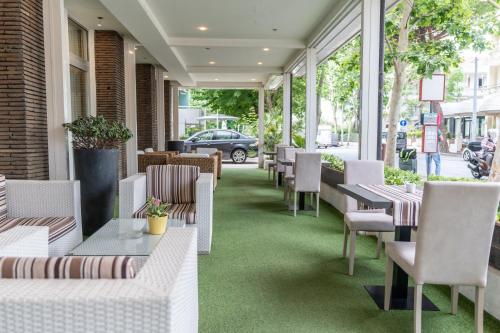 a restaurant with tables and chairs on a street at Hotel Majorca sul Mare in centro a Riccione con Area Fitness in Riccione