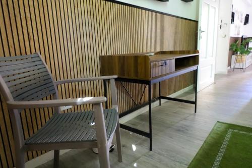 a wooden desk and a chair in a room at Health House in Sassari