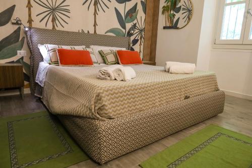 a bedroom with a large bed with orange pillows at Health House in Sassari