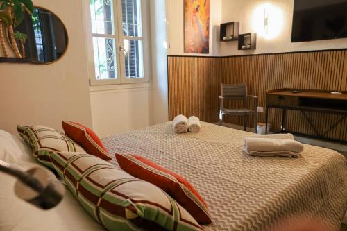 a bedroom with a bed with towels on it at Health House in Sassari