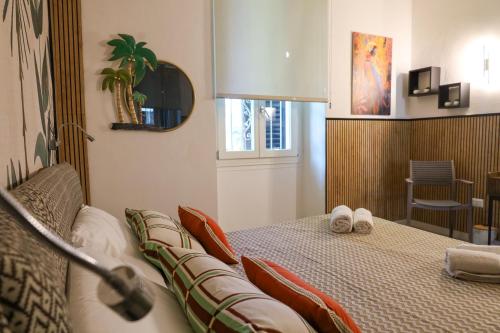 a bedroom with a bed with towels on it at Health House in Sassari