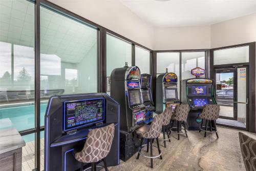 a row of slot machines in a room with windows at Best Western Plus Great Northern Inn in Havre