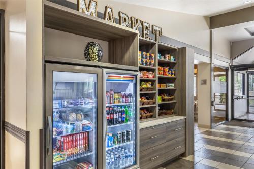 a refrigerator filled with lots of drinks in a room at Best Western Plus Great Northern Inn in Havre