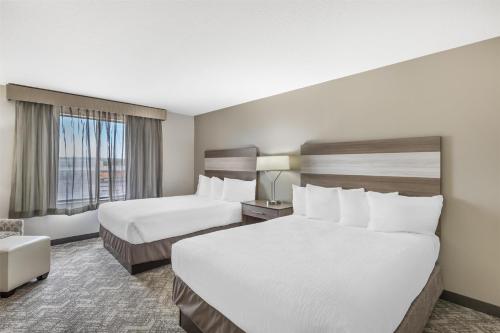 a hotel room with two beds and a window at Best Western Plus Great Northern Inn in Havre