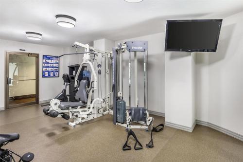 a room with a gym with a flat screen tv at Best Western Plus Great Northern Inn in Havre