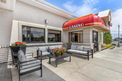 a restaurant with chairs and a dining sign on a building at Best Western Plus Great Northern Inn in Havre