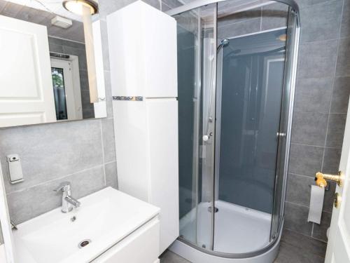 a bathroom with a shower and a sink at 6 person holiday home in Thyholm in Thyholm
