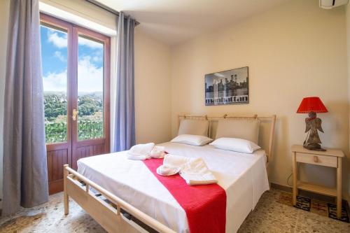a bedroom with a bed with a large window at Villa with Sea View Parking in Lapedona