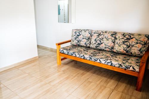 a couch sitting on a wooden floor in a room at Espaço Villa Verde in Ibiúna