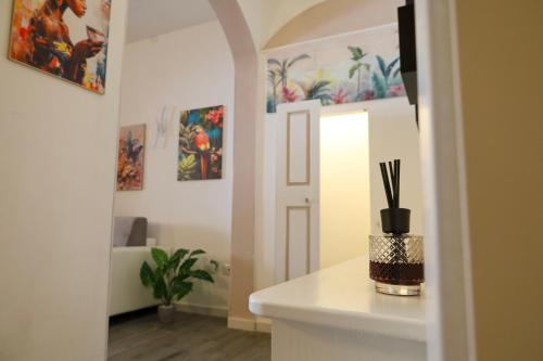 a hallway with a room with paintings on the walls at Health House in Sassari
