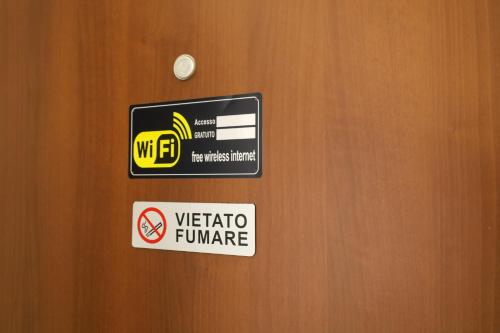a sign on a door with a sign on it at Health House in Sassari