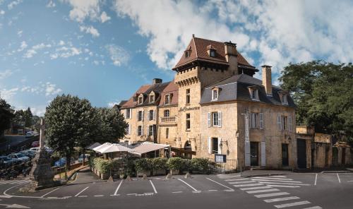 an old building with a tower on top of it at Hôtel La Couleuvrine Sarlat Centre Ville in Sarlat-la-Canéda
