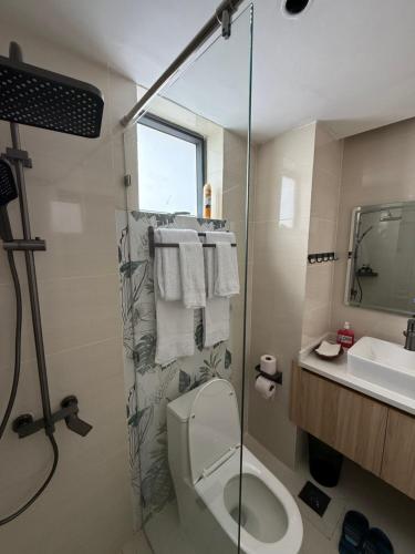 a bathroom with a shower and a toilet and a sink at Chic Retreat Near JKIA and SGR with Nairobi National Park Views in Nairobi