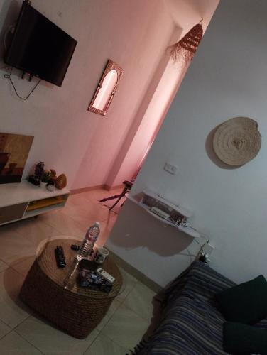 a living room with a guitar and a couch at Appartement 2 à Carthage byrsa in Douar ech Chott