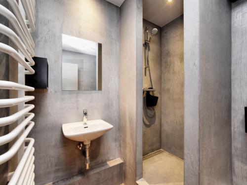 a bathroom with a sink and a mirror at Fancy Holiday Home in Sainte-Cécile with Pool House & Indoor Pool in Sainte-Cécile