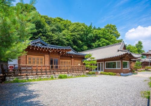 a house with a fence in front of it at Yongin Yejik Hanok Pension in Yongin