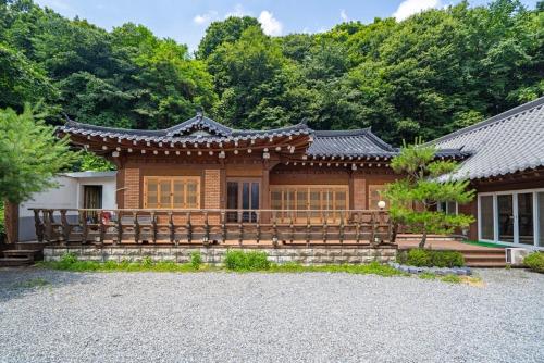 a house with a fence in front of it at Yongin Yejik Hanok Pension in Yongin