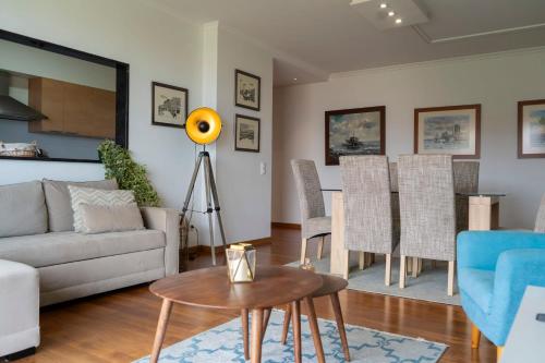 a living room with a couch and a table at Casa da Baía Overlooking Funchal Bay in Funchal