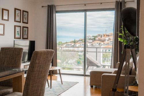 a living room with a view of a city at Casa da Baía Overlooking Funchal Bay in Funchal