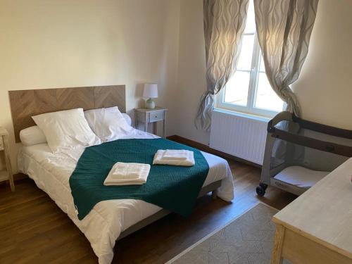 a bedroom with a bed with two towels on it at Gîte de campagne avec terrasse et tous équipements à Mazirat - FR-1-489-385 in Mazirat