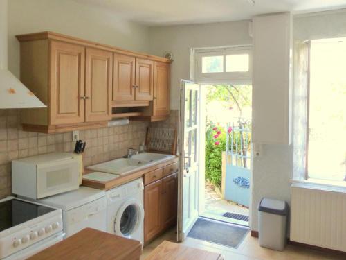 a kitchen with a sink and a washing machine at Maison rénovée avec vue sur château, animaux acceptés, terrasse panoramique - FR-1-489-164 in Billy