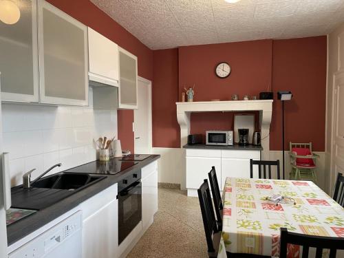a kitchen with a sink and a table with chairs at Maison de ferme rénovée avec terrasse, jardin et équipements modernes à Taxat-Senat - FR-1-489-363 in Taxat-Senat