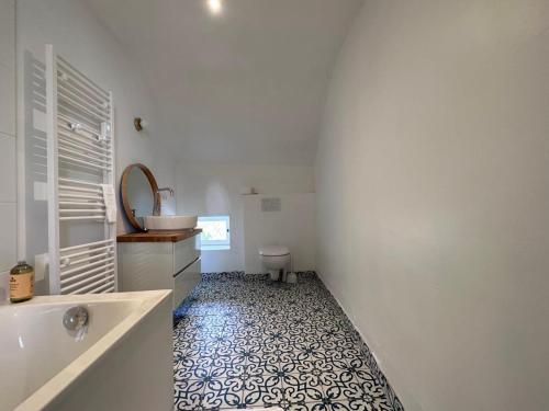 a bathroom with a tub and a sink and a toilet at Charmante Cure Ancienne avec Jardin et WiFi, Près de Vichy - FR-1-489-459 in Jaligny