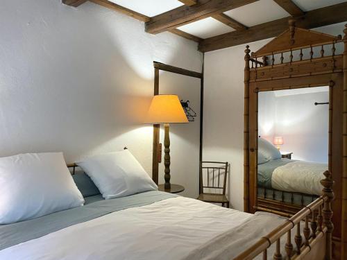 a bedroom with a bed and a large mirror at Charme authentique et moderne dans une longère bourbonnaise - FR-1-489-397 in Hyds