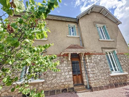 a large stone building with windows and a door at Gîte tranquille avec jardin, parking et Wi-Fi à La Ferté-Hauterive - FR-1-489-549 in La Ferté-Hauterive
