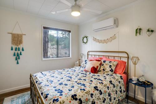 a bedroom with a bed and a window at 2 Mi to Arizona Christmas City! Cabin with Fireplace in Prescott