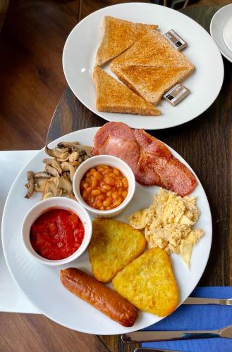 two plates of breakfast food with different types of foods at Trivelles Regency, Nottingham in Nottingham