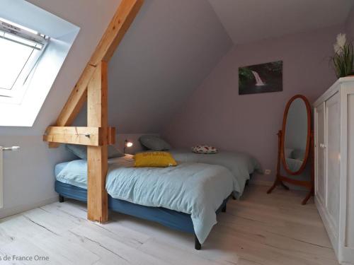 a bedroom with two beds in a attic at Maison ancienne avec sauna, babyfoot, billard, proche station thermale et forêt domaniale - FR-1-497-136 in La Chapelle d'Audaine