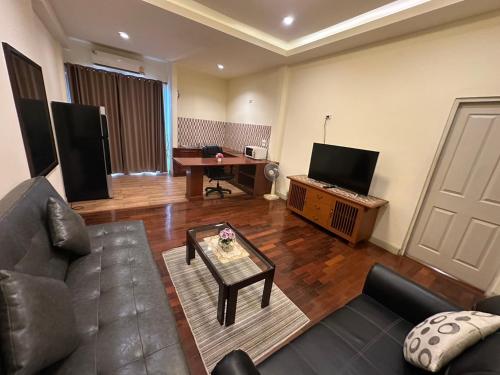 a living room with a couch and a table at Prince Hotel Chiang Mai in Chiang Mai