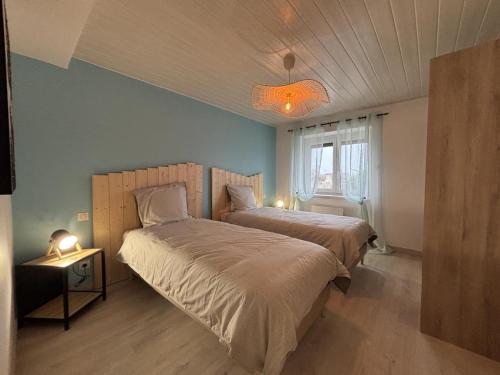 a bedroom with two beds and a window at Gîte paisible 6 pers proche Vichy et Clermont-Ferrand - FR-1-489-566 in Cognat-Lyonne