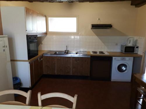 a small kitchen with a sink and a stove at Gîte de charme en Sologne, 6 pers, équipements complets, idéal découvertes nature et châteaux - FR-1-491-333 in Souvigny-en-Sologne