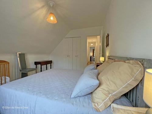 a bedroom with a large bed with blue pillows at Grande maison familiale avec jardin, garage et jeux pour enfants - Parfait pour 15 personnes en Normandie. - FR-1-497-206 in Longny-au-Perche