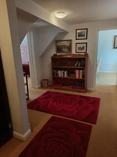 a living room with a red rose carpet at Chandeliers 6 in Shrewsbury