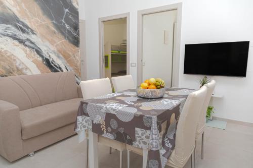 a dining room with a table with a bowl of fruit on it at Zoe's apartment in Alghero
