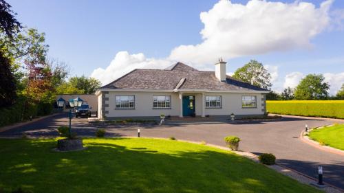 una casa blanca con una puerta verde en una entrada en Room 4 - Anglers Rest Carrick, en Carrick on Shannon