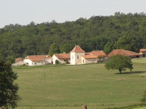 a group of houses in a field with trees at Gîte de charme 17ème s. avec jardin clos, proche forêt et Aubeterre, internet fibre, animaux OK - FR-1-653-42 in Saint-Romain