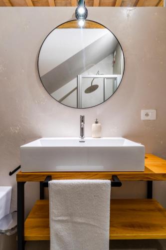 a bathroom with a white sink and a mirror at Garden apartment, wifi and private parking in Porto SantʼElpidio