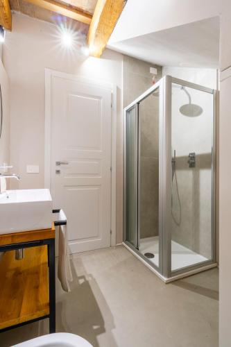 a bathroom with a shower with a glass door at Garden apartment, wifi and private parking in Porto SantʼElpidio