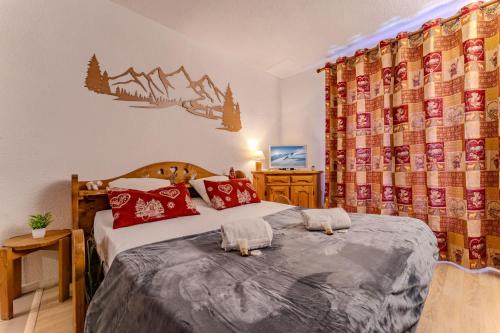 a bedroom with two beds with red pillows at 2bedroom in Heart of Val Thorens Ski-In and Parking 2 Niv in Val Thorens
