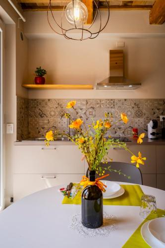 a vase with yellow flowers sitting on a table at Garden apartment, wifi and private parking in Porto SantʼElpidio