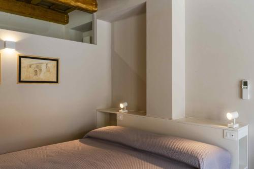 a bedroom with a bed and two candles on the wall at Garden apartment, wifi and private parking in Porto SantʼElpidio