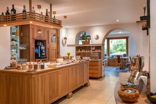 a large kitchen with a counter in a room at Hotel Brunello in Ortisei