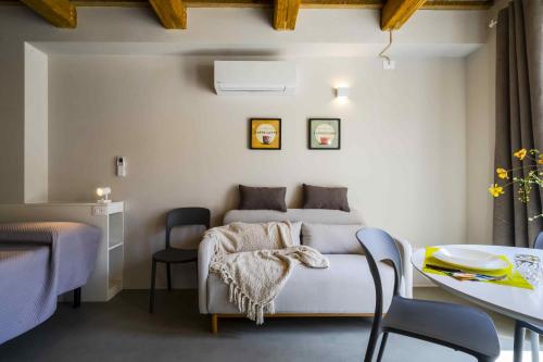 a bedroom with a bed and a table and chairs at Garden apartment, wifi and private parking in Porto SantʼElpidio
