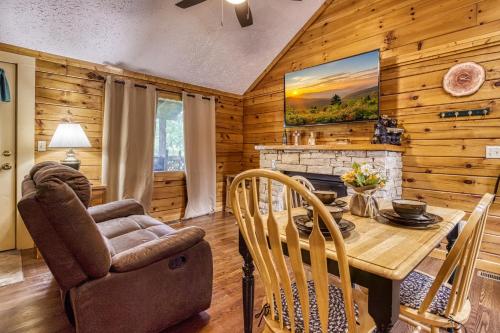 a dining room with a table and a fireplace at Forever Yours, 2 Hot tubs, FREE Attraction tickets, WIFI, Near The Parkway in Pigeon Forge!!! in Pigeon Forge